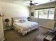 Bright bedroom featuring a comfortable king-sized bed, ceiling fan, and a sun-filled window at 1890 Bel Lago Vw, Monument, CO 80132