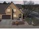 Charming two-story home featuring a stucco facade, stone accents, and an attached two-car garage at 1890 Bel Lago Vw, Monument, CO 80132