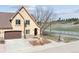 Charming home featuring a two-car garage, stone accents and manicured front yard at 1890 Bel Lago Vw, Monument, CO 80132