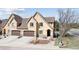 Inviting home features a two-car garage, stone accents, and a manicured front yard at 1890 Bel Lago Vw, Monument, CO 80132