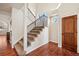 Inviting foyer features a staircase with iron railings and hardwood floors at 1890 Bel Lago Vw, Monument, CO 80132