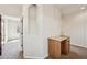 Hallway with a decorative shelf, wooden cabinets, and stone countertops at 1890 Bel Lago Vw, Monument, CO 80132