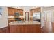Well-lit kitchen boasts a spacious island with granite countertops and wooden cabinetry at 1890 Bel Lago Vw, Monument, CO 80132