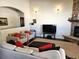 Inviting living room features a stone fireplace, plush seating, and natural light at 1890 Bel Lago Vw, Monument, CO 80132