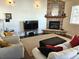 Spacious living room boasting a stone fireplace, comfortable seating, and a warm ambiance at 1890 Bel Lago Vw, Monument, CO 80132