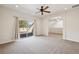This living room features a ceiling fan, arched entryway and sliding doors to a deck at 1890 Bel Lago Vw, Monument, CO 80132
