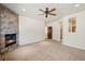 Spacious carpeted main bedroom featuring a stone fireplace and a ceiling fan at 1890 Bel Lago Vw, Monument, CO 80132