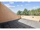 Private outdoor patio offers relaxing views with paved floor and stucco walls at 1890 Bel Lago Vw, Monument, CO 80132