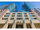 An upward view of condo buildings, highlighting the architecture and design with blue windows and brick accents at 1700 Bassett St # 513, Denver, CO 80202