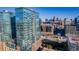 Exterior view of modern high-rise buildings featuring glass facades, balconies, and a cityscape backdrop at 1700 Bassett St # 513, Denver, CO 80202
