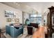 Bright living room with hardwood floors, stylish furnishings, and floor-to-ceiling windows at 1700 Bassett St # 513, Denver, CO 80202