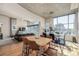 Open living space with hardwood floors, modern furniture, and large windows with city views at 1700 Bassett St # 513, Denver, CO 80202