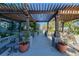 Walkway with wooden pergola and planters offers a serene outdoor space with comfortable seating at 1700 Bassett St # 513, Denver, CO 80202