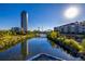 Scenic view of the community's river, surrounded by lush greenery and modern buildings under a clear sky at 1700 Bassett St # 513, Denver, CO 80202