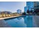 Rooftop swimming pool with lounge chairs and tables for relaxing in a modern building complex at 1700 Bassett St # 513, Denver, CO 80202