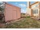 View of the backyard featuring a shed, grass and the house, perfect for enjoying outdoor activities at 2208 S Eldridge Ct, Lakewood, CO 80228