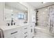 Modern bathroom featuring double vanity, stylish tile, and tub with shower at 2208 S Eldridge Ct, Lakewood, CO 80228