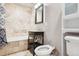 Elegant bathroom featuring stone tile, vanity, and bidet, creating a spa-like retreat at 2208 S Eldridge Ct, Lakewood, CO 80228