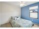 Cozy bedroom with blue accent wall and a large window at 2208 S Eldridge Ct, Lakewood, CO 80228