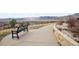 A bench sits beside a neighborhood walking path, offering a relaxing space to take in the scenery at 2208 S Eldridge Ct, Lakewood, CO 80228