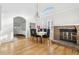 Formal dining room with hardwood floors, fireplace, and a large window letting in natural light at 2208 S Eldridge Ct, Lakewood, CO 80228