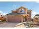 Charming two-story home features a well-maintained lawn, brick accents, and an attached two-car garage at 2208 S Eldridge Ct, Lakewood, CO 80228