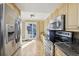 Kitchen featuring stainless steel appliances, hardwood floors, and a sliding glass door to the backyard at 2208 S Eldridge Ct, Lakewood, CO 80228