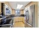 Bright kitchen featuring stainless steel appliances, light wood cabinets, and a granite countertop at 2208 S Eldridge Ct, Lakewood, CO 80228