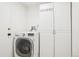 Functional laundry room with washer, dryer, and storage cabinets, offering convenience and organization at 2208 S Eldridge Ct, Lakewood, CO 80228