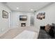 Comfortable living room features plush carpeting, a modern fireplace, and sleek black leather seating at 2208 S Eldridge Ct, Lakewood, CO 80228