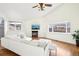 Spacious living room featuring vaulted ceilings, hardwood floors, and large windows for natural light at 2208 S Eldridge Ct, Lakewood, CO 80228