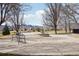 Park featuring a concrete pad, benches, statue, trees, and stunning mountain views at 2208 S Eldridge Ct, Lakewood, CO 80228