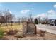 Coyote Gulch Park sign featuring a stone base, park information, and manicured landscaping at 2208 S Eldridge Ct, Lakewood, CO 80228