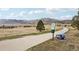 Paved walking path lined by trees and a mountain backdrop, perfect for exercise and relaxation at 2208 S Eldridge Ct, Lakewood, CO 80228