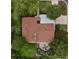 Bird's eye view of the property highlighting the roof, landscaping, and surrounding trees at 5880 S Happy Canyon Dr, Cherry Hills Village, CO 80111