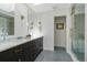 Elegant bathroom features a double sink vanity with marble countertop and modern fixtures at 5880 S Happy Canyon Dr, Cherry Hills Village, CO 80111