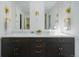 Stylish bathroom vanity with double sinks, dark wood cabinets, and gold accents at 5880 S Happy Canyon Dr, Cherry Hills Village, CO 80111