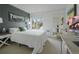 Stylish bedroom with comfortable bed, large windows, and cool blue accent wall at 5880 S Happy Canyon Dr, Cherry Hills Village, CO 80111