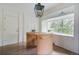 Bright breakfast nook featuring a light wood island, ample storage, and a charming window seat at 5880 S Happy Canyon Dr, Cherry Hills Village, CO 80111