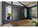 Beautiful foyer with double entry doors, wooden floors, and windows on either side at 5880 S Happy Canyon Dr, Cherry Hills Village, CO 80111