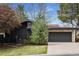 Charming single Gathering home with a red tile roof, gray garage door, and well-maintained lawn at 5880 S Happy Canyon Dr, Cherry Hills Village, CO 80111