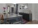Open concept kitchen featuring a center island, gray cabinets, and stainless steel appliances at 5880 S Happy Canyon Dr, Cherry Hills Village, CO 80111