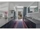 Modern eat-in kitchen with an island, black cabinets, stainless steel appliances, and a marble backsplash at 5880 S Happy Canyon Dr, Cherry Hills Village, CO 80111