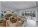 Sun-filled open floor plan with a dining area, living room, and outdoor patio at 5880 S Happy Canyon Dr, Cherry Hills Village, CO 80111