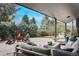 Inviting covered patio area with a cozy fire pit and comfortable seating for relaxing and entertaining at 5880 S Happy Canyon Dr, Cherry Hills Village, CO 80111