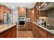 Modern kitchen with double oven, granite counters, and wood cabinets at 2253 Imperial Ln, Superior, CO 80027