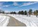 Paved trail winding through a snowy park landscape at 2253 Imperial Ln, Superior, CO 80027