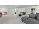 Spacious basement features plush carpeting, a gray sectional couch, and entertainment center at 10291 Carrara Ter, Parker, CO 80134