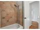 Well-lit bathroom features mosaic tile accents, a shower head, and a soaking tub at 10291 Carrara Ter, Parker, CO 80134