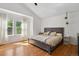 Sun-filled main bedroom with hardwood floors, vaulted ceiling, and large windows at 10291 Carrara Ter, Parker, CO 80134